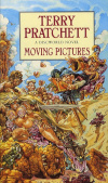 Cover of the book Moving Pictures by Terry Pratchett. The sky is blue, there is sand on the ground, probably it's a beach. There is a troll made of rock lying on the ground looking up angrily. There is a blond, voluptuous, scantily-clad woman sitting on top of the Troll. Just above her there is a man holding a sword through her hair. There is a chef standing behind them, and there are hotdogs flying in the air, seemingly using the buns as wings. To the right of the man with the sword there is someone holding a video camera with a crank on it. They hold on to the crank and look panicked. Behind the camera man there is another person in wizard's robes shouting through a megaphone. Behind the man with the sword there is a dusty and large Oscar trophy statue.